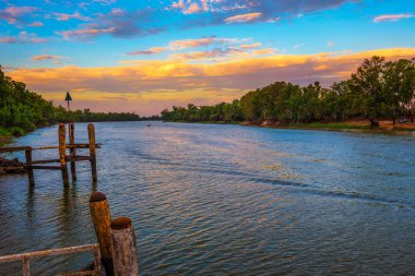 Colorful sunset over Murray river in Mildura, Australia. The Murray River is one of Australias longest and most significant rivers, stretching from the Australian Alps to the Southern Ocean. clipart