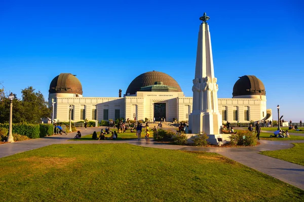 stock image Los Angeles, California - June 14, 2022 : Griffith Observatory with tourists against clear blue sky. The observatory is a popular tourist attraction with excellent views over Hollywood Hills and sign.