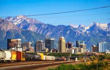 Skyline of Salt Lake City downtown in Utah with Wasatch Range Mountains in the background.