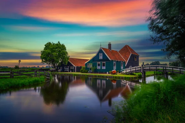 アムステルダム近くのザーンセ スキャンの聖地村の歴史的な農家の家の上にカラフルな夕日は 水の中に美しい反射と 長時間露光 — ストック写真