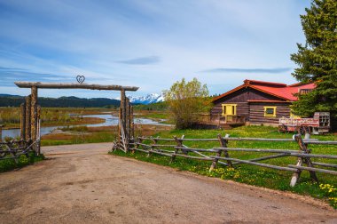 Moran, Wyoming, USA - June 8, 2022 : Buffalo Valley Ranch at the Buffalo Fork of the Snake River with the Grand Teton mountains in the background.