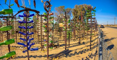 Oro Grande, California, USA - November 03, 2023 : Elmers Bottle Tree Ranch on historic Route 66 in California, an outdoor bottle art installation. clipart