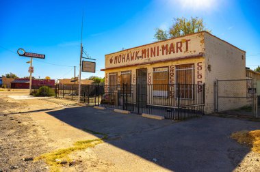 Oro Grande, Kaliforniya, ABD - 3 Kasım 2023: Oro Grande 'de tarihi Route 66' da terk edilmiş Mohawk Mini Mart mağazası ve benzin istasyonu, klasik neon levhası, tahta pencereler ve çitli giriş.