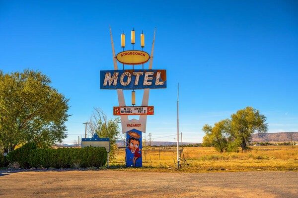 Seligman, Arizona, USA - November 4, 2023 : The Stagecoach 66 Motel neon sign and building located on historic Route 66 in Seligman, Arizona, captures a nostalgic roadside scene under a clear sky.