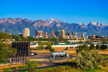 Skyline of Salt Lake City downtown in Utah with Wasatch Range Mountains in the background.