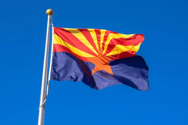 stock image Arizona state flag waving in the wind against a cloudless bright blue sky