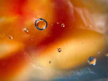 Çiçeklerin arka planına karşı bardağın üzerine büyük bir damla su. Soyutlama. Yaz. Makro. Yüksek kalite fotoğraf