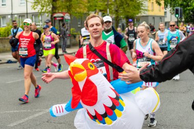 LONDON, UK - 21ST APRIL 2024: People dressed up and  running in the London Marathon 2024 mass run clipart