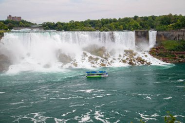 NIAGARA FALLS, CANADA - 27TH JUL 2022: A large group of people on the Maid of the Mist boat in Niagara Falls. clipart