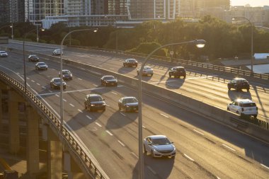 TORONTO, CANADA, 26TH JULY 22: The Toronto Gardiner Expressway during the early evening. Lots of cars can be seen on the road. Buildings and condos can be seen in the background. clipart