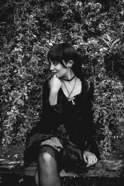Young Skinny Hispanic Goth Girl Black Dress Cross Seated Rustic — Stock Photo, Image