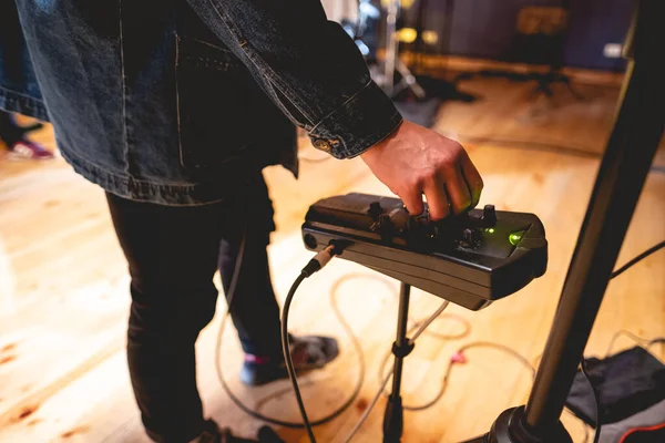 Hand of musician using a music console in studio