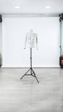 Fashionable white mannequin of headless woman torso with arms over white background (with big copy space)