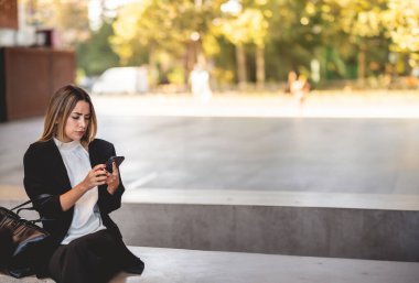 Halka açık bir yerde kahve molası: Güzel ve gevşemiş, kahve fincanı kullanan Latin bir yönetici.