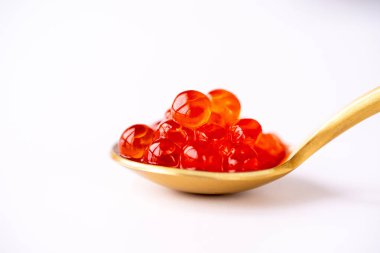 Salmon Red caviar white background.Red fish caviar on a spoon.Luxury delicacy food.Red caviar in the spoon isolated on a white background.Raw seafood.Macro fish caviar.Delicacy food on white isolated 