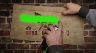 Go green spray painted inscription on the brick wall. Urban abstract artwork. Graffiti art concept of eco friendly ecology and environment. Airbrush paint with text template in hand.
