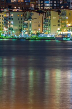 Gothenburg, Sweden - October 09 2022: Long exposure night photo of the river and apartment buildings at Eriksberg.