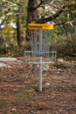 Gothenburg, Sweden - October 16 2022: Disc golf basked in a forest.