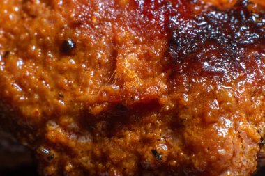 Macro detail of the crust of a grilled chicken filet.