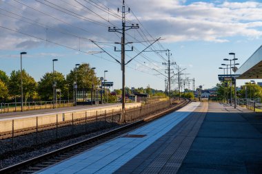 Kungsbacka, Sweden - september 11 2022: Railway tracks curving at the end of a station platform.