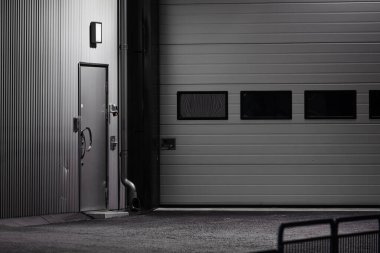 Grey warehouse port at night.