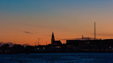 Ockero, Sweden - July 24 2020: Silhouettes of buildings and the church on cker island.