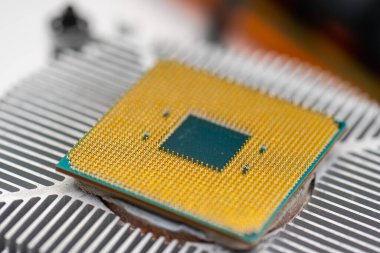 Back of a AMD socket AM4 CPU mounted on a cooler.