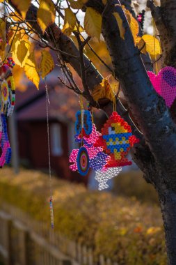 Gothenburg, Sweden - October 30 2022: Plastic bead art hanging from a tree.