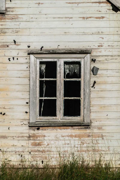 stock image Window of old abandoned white wooden house.