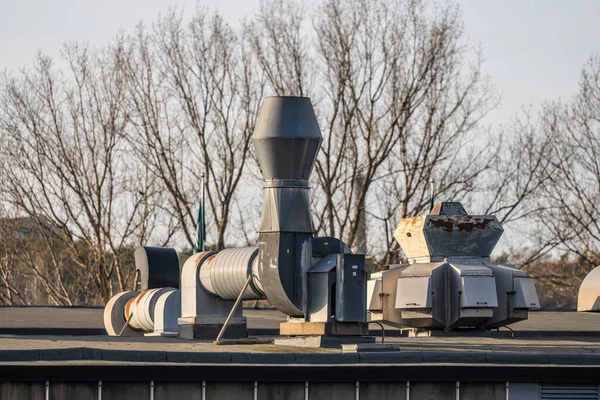 Ventilation duct and fan on the roof of a building.