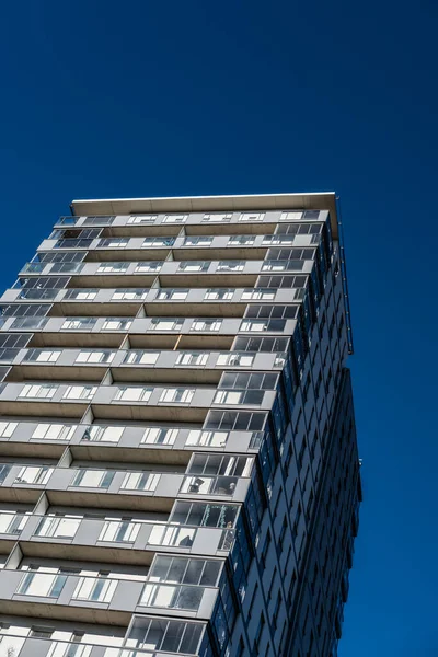 Stock image High rise apartment building against blue sky.