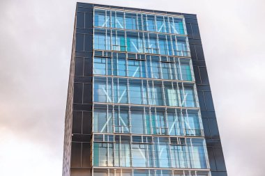 Malmo, Sweden - July 09 2022: Looking up a tall glass and metal office building.