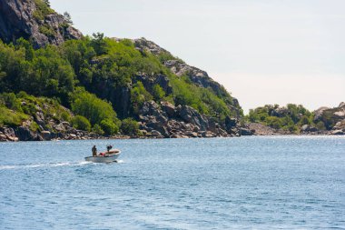 Güneşli bir günde, küçük bir teknede denize açılıyorlar..