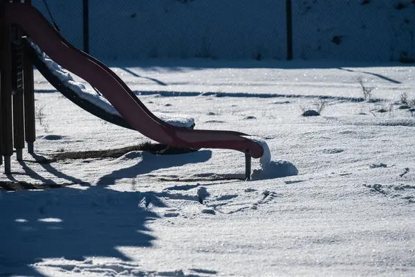 stock image Snow running of a disused slide at a playground.