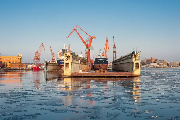 stock image Gothenburg, Sweden - February 04 2012: Floating dock and wharf cranes at Lindholmen at winter.