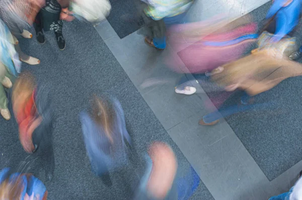 stock image People moving around the floor of a book fair.