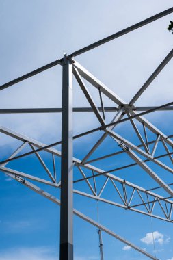White painted steel beams and girders of a warehouse under construction.