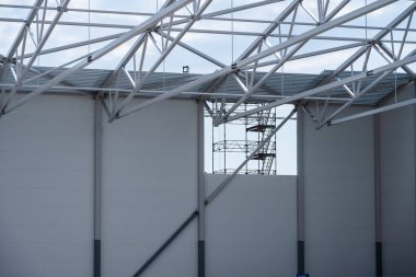 White painted steel beams and girders of a warehouse under construction.