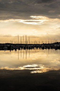 Golden sunset over a large marina in spring.