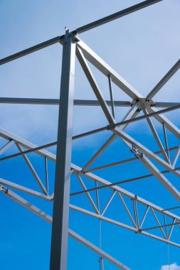 White painted steel beams and girders of a warehouse under construction.