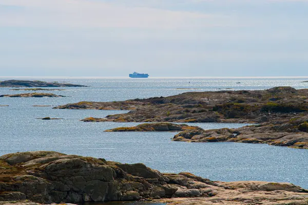 stock image Gothenburg, Sweden - April 29 2012: Large container ship at sea with barren cliffs and islands in the foreground.