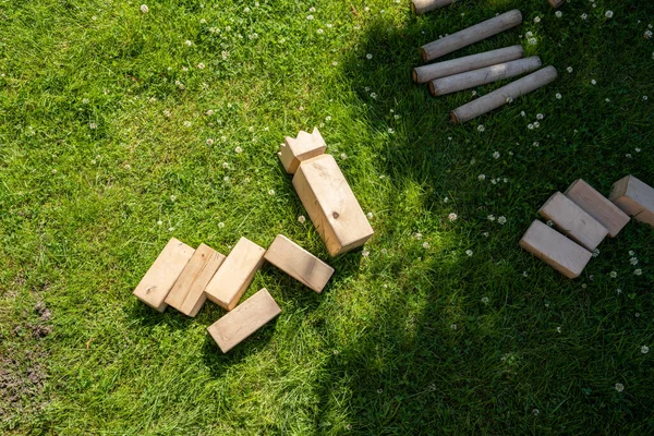 Traditional Swedish park game Kubb on a lawn.