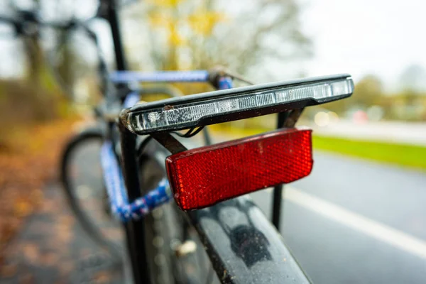 Reflex and rear lights of a black bicycle.