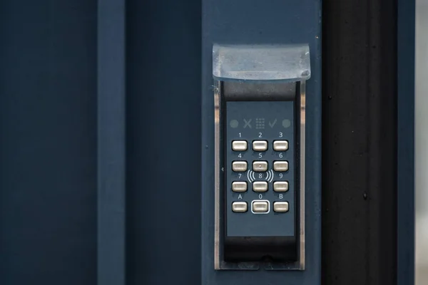 Keypad by an entrance door at a warehouse.