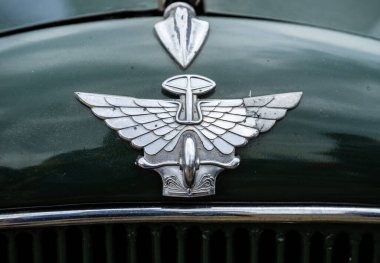 Kjeller, Norveç - 18 Haziran 2023: Yeşil bir arabanın üzerindeki klasik Austin kaput süsü.