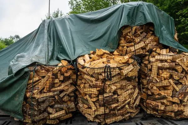 Fire wood packed in sacks on pallets.