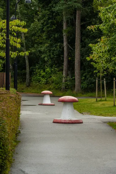 Concrete -road blocks formed to look like mushrooms.