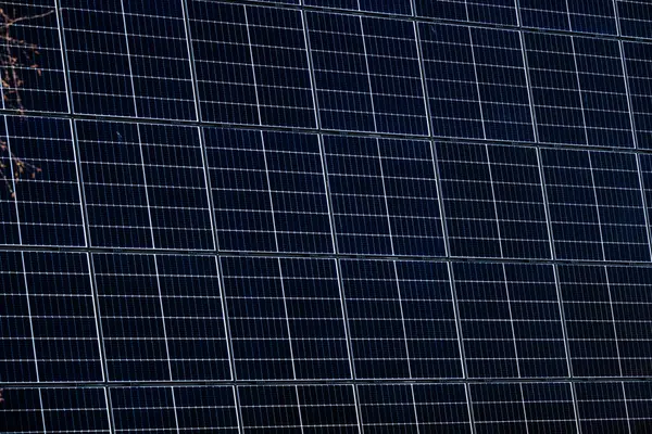 stock image Multiple Solar panels on a warehouse wall.