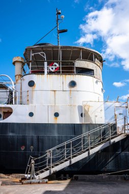 Limanda iskelesi olan eski paslı gemi..