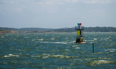 Rüzgarlı kıyı sularında tek bir fener duruyor.